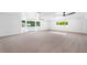 Bright and open living room featuring neutral carpeting, large windows and modern ceiling fans at 3417 1St W Ave, Bradenton, FL 34205
