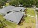 Bird's-eye view showcasing a home's manicured lawn, newly installed roof, and landscaped surroundings at 4009 Carrollwood Village Dr, Tampa, FL 33618