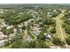 Aerial view of community surrounded by lush landscaping, pond, and golf course at 4009 Carrollwood Village Dr, Tampa, FL 33618
