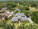 Stunning aerial view of home with lush landscaping, pool, water feature, and golf course in the distance at 4009 Carrollwood Village Dr, Tampa, FL 33618