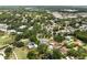 Panoramic aerial shot capturing a neighborhood's lush landscaping, swimming pools, and scenic ponds at 4009 Carrollwood Village Dr, Tampa, FL 33618