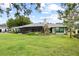 Lush backyard featuring a screened patio and mature landscaping at 4009 Carrollwood Village Dr, Tampa, FL 33618