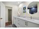 Bright bathroom with double sink vanity with quartz countertop and round mirrors at 4009 Carrollwood Village Dr, Tampa, FL 33618