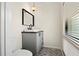 Cozy half bathroom with patterned floor tiles, a modern vanity, and a decorative pendant light at 4009 Carrollwood Village Dr, Tampa, FL 33618