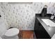 Charming powder room with black vanity, unique dog-themed wallpaper, and brick flooring at 4009 Carrollwood Village Dr, Tampa, FL 33618