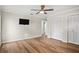 Bedroom featuring hardwood floors, a ceiling fan, and double-door closets at 4009 Carrollwood Village Dr, Tampa, FL 33618
