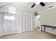 Bedroom featuring neutral walls, a ceiling fan, and a double door closet at 4009 Carrollwood Village Dr, Tampa, FL 33618