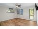 Bedroom featuring wood floors, a ceiling fan, and bright windows at 4009 Carrollwood Village Dr, Tampa, FL 33618
