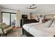 Primary bedroom with a dark wood bed frame, a large rug, and access to the screened in patio at 4009 Carrollwood Village Dr, Tampa, FL 33618