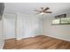 Bedroom featuring wood floors, a ceiling fan, and a double door closet at 4009 Carrollwood Village Dr, Tampa, FL 33618