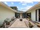 Courtyard featuring stone pavers and lush landscaping, perfect for outdoor relaxation at 4009 Carrollwood Village Dr, Tampa, FL 33618