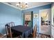 Cozy dining room featuring wood floors, blue walls and view into the kitchen at 4009 Carrollwood Village Dr, Tampa, FL 33618
