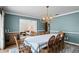 Bright dining room featuring an ornate chandelier, hardwood floors, and an open view to the living room at 4009 Carrollwood Village Dr, Tampa, FL 33618