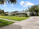 Well-maintained home featuring a lush green lawn and manicured landscaping at 4009 Carrollwood Village Dr, Tampa, FL 33618
