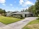 A single-story home featuring manicured lawns and landscaping creating curb appeal at 4009 Carrollwood Village Dr, Tampa, FL 33618