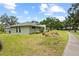 A neatly landscaped property with healthy green grass and mature trees, providing curb appeal at 4009 Carrollwood Village Dr, Tampa, FL 33618