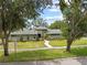 A well-maintained home with a curved walkway, a manicured lawn, and mature landscaping at 4009 Carrollwood Village Dr, Tampa, FL 33618