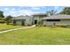 Charming single story home with lush lawn and mature landscaping at 4009 Carrollwood Village Dr, Tampa, FL 33618