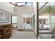 Bright hallway with high ceilings, brick floor, statement art, and natural light from the windows at 4009 Carrollwood Village Dr, Tampa, FL 33618
