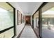 Hallway with modern flooring and sliding doors to the outdoor patio at 4009 Carrollwood Village Dr, Tampa, FL 33618