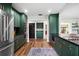 Green kitchen featuring stainless steel appliances, dual ovens, and black countertops at 4009 Carrollwood Village Dr, Tampa, FL 33618