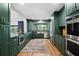 Stylish kitchen featuring green cabinetry, stainless steel appliances, modern fixtures, and plenty of counter space at 4009 Carrollwood Village Dr, Tampa, FL 33618