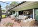 Spacious outdoor lanai featuring a dining area and living space with views of the backyard at 4009 Carrollwood Village Dr, Tampa, FL 33618