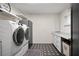 Laundry room equipped with modern washer, dryer, and ample storage space at 4009 Carrollwood Village Dr, Tampa, FL 33618