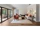 Inviting living room featuring hardwood floors and access to screened in patio at 4009 Carrollwood Village Dr, Tampa, FL 33618