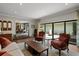 Elegant living room with plush seating, hardwood floors, and a view to both the dining area and outdoor patio at 4009 Carrollwood Village Dr, Tampa, FL 33618