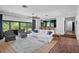 Bright living room features sliding glass doors to a patio and a kitchen view at 4009 Carrollwood Village Dr, Tampa, FL 33618