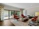 Inviting living room with hardwood floors, natural light, sliding glass doors to the patio, and stylish furnishings at 4009 Carrollwood Village Dr, Tampa, FL 33618