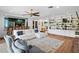 Spacious living room with white sofa, brick floors, and built-in bookshelves at 4009 Carrollwood Village Dr, Tampa, FL 33618