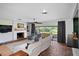 Open living room features fireplace, brick flooring, and sliding doors to the outdoors at 4009 Carrollwood Village Dr, Tampa, FL 33618