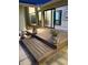 Serene outdoor deck area with stone and wood flooring, enhanced by subtle lighting and lush potted plants at 4009 Carrollwood Village Dr, Tampa, FL 33618