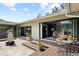 Inviting patio area featuring stone and wood flooring, potted plants, and seamless indoor-outdoor transition at 4009 Carrollwood Village Dr, Tampa, FL 33618