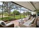 Relaxing screened-in patio with comfortable seating and serene views of the backyard at 4009 Carrollwood Village Dr, Tampa, FL 33618