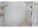 Modern shower featuring white honeycomb tile, bronze fixtures, and a built-in shower bench at 4009 Carrollwood Village Dr, Tampa, FL 33618