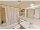 A bathroom with a shower/tub combination, a standard vanity, wood look laminate flooring and an iron shelf at 4215 East Bay Dr # 1103D, Clearwater, FL 33764