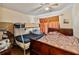A bedroom with a twin/double bunk bed, a dresser and a queen bed featuring wood laminate flooring at 4215 East Bay Dr # 1103D, Clearwater, FL 33764