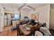 A dining room with a wood dining table, laminate floors, ceiling fan, and adjacent to the kitchen area at 4215 East Bay Dr # 1103D, Clearwater, FL 33764