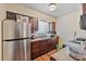 Functional kitchen featuring wood cabinets, a stainless steel refrigerator, and laminate flooring at 4215 East Bay Dr # 1103D, Clearwater, FL 33764