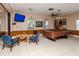 A community recreation room with a billiards table, a flat-screen TV, comfortable chairs, and tile flooring at 4215 East Bay Dr # 1103D, Clearwater, FL 33764