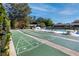 Recreational shuffleboard courts near the pool with lounge chairs, greenery and a blue sky at 4215 East Bay Dr # 1103D, Clearwater, FL 33764