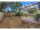 Large fenced-in backyard with a cozy deck area and overhead pergola and some trees for a bit of shade at 4432 W Mccoy St, Tampa, FL 33616