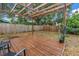 Wooden deck under a pergola within a fenced backyard, creating a private outdoor retreat at 4432 W Mccoy St, Tampa, FL 33616