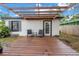 Cozy backyard deck with pergola and string lights, perfect for outdoor relaxation and entertaining at 4432 W Mccoy St, Tampa, FL 33616