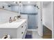 Modern bathroom vanity with gold fixtures and a glass shower enclosure at 4432 W Mccoy St, Tampa, FL 33616