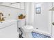 Bathroom with white walls and brass hardware plus a walk-in shower at 4432 W Mccoy St, Tampa, FL 33616