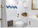 Bathroom with white tile, blue accents, and gold fixtures at 4432 W Mccoy St, Tampa, FL 33616